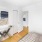a room with a white wall and a wood floor