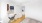 a room with a white wall and a wood floor