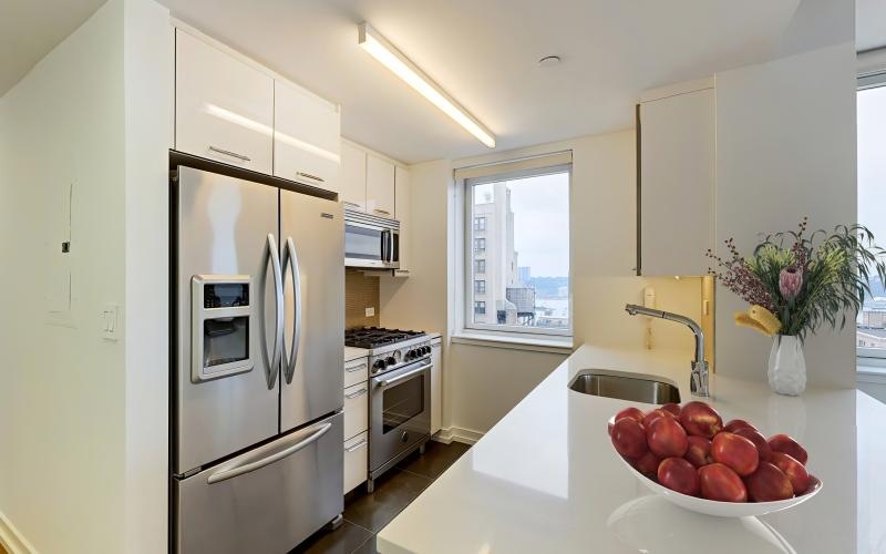 a kitchen with white cabinets