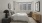 a bedroom with a bed and a lamp