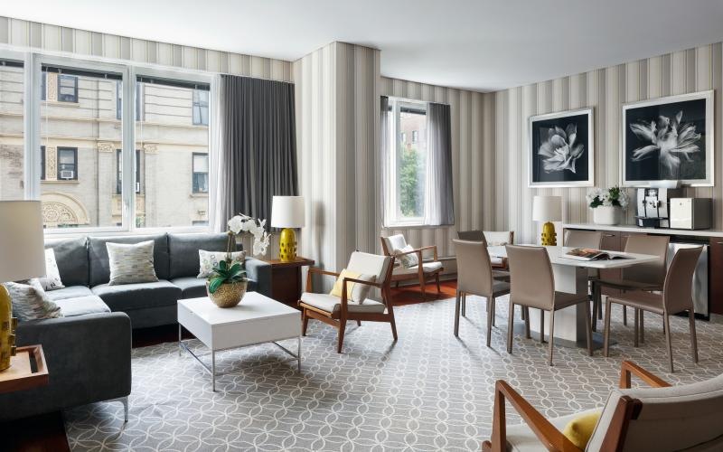 a living room with a large table and chairs